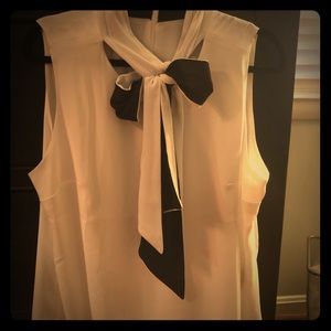 White blouse with a dual sided black and white tie